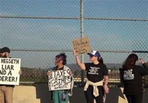 تجمع اعتراضی علیه وزیر جنگ آمریکا در جریان سفرش به آلاباما